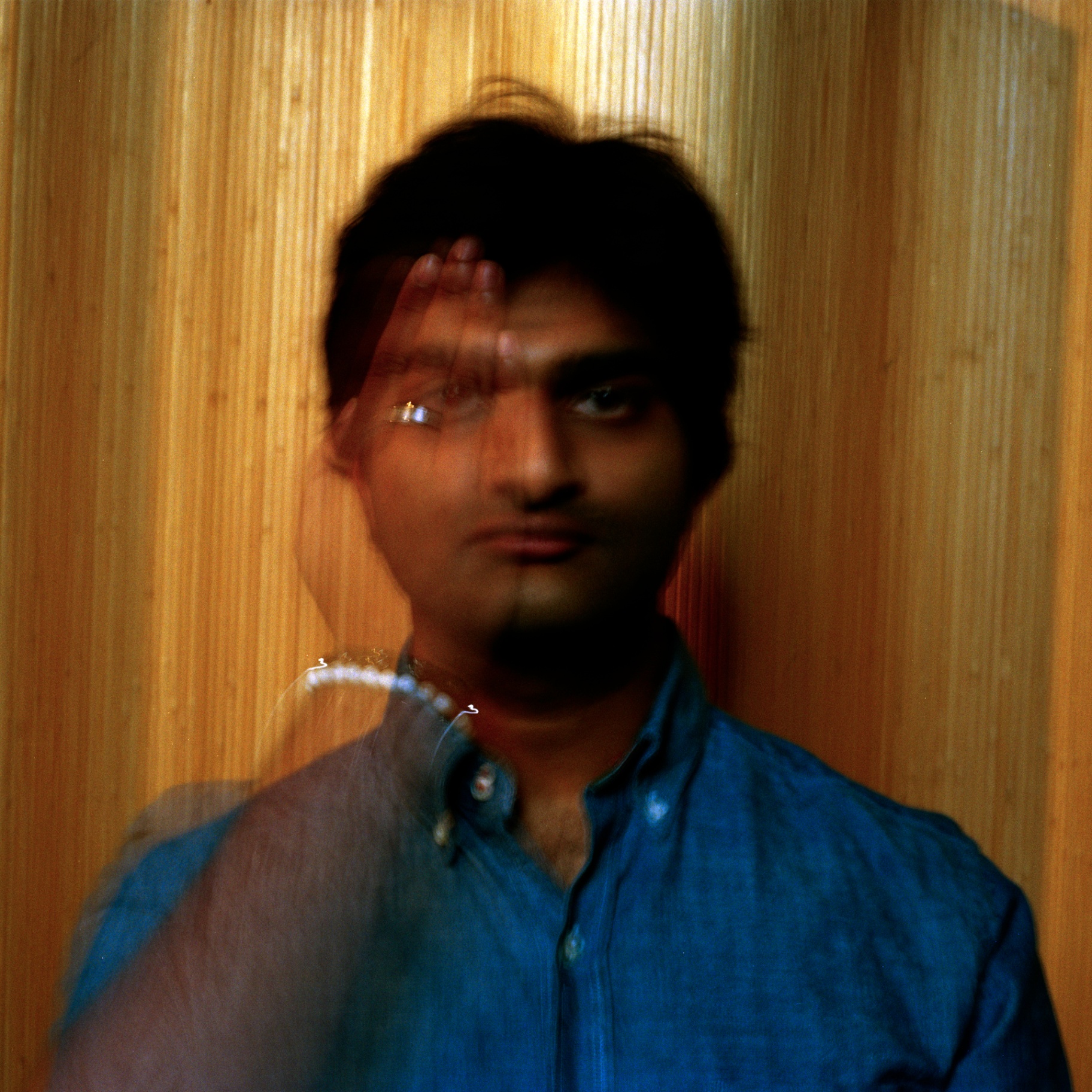 Eshan Agarwal portrait with motion blur against wood grain